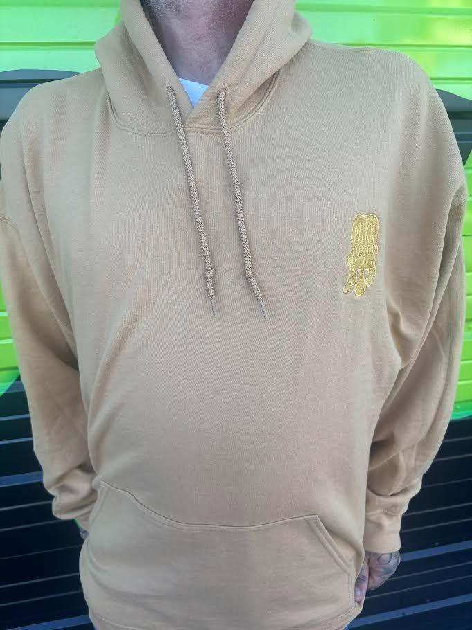Nikk Drips Hoodie in beige with a yellow logo on the chest, featuring a comfortable and stylish design.