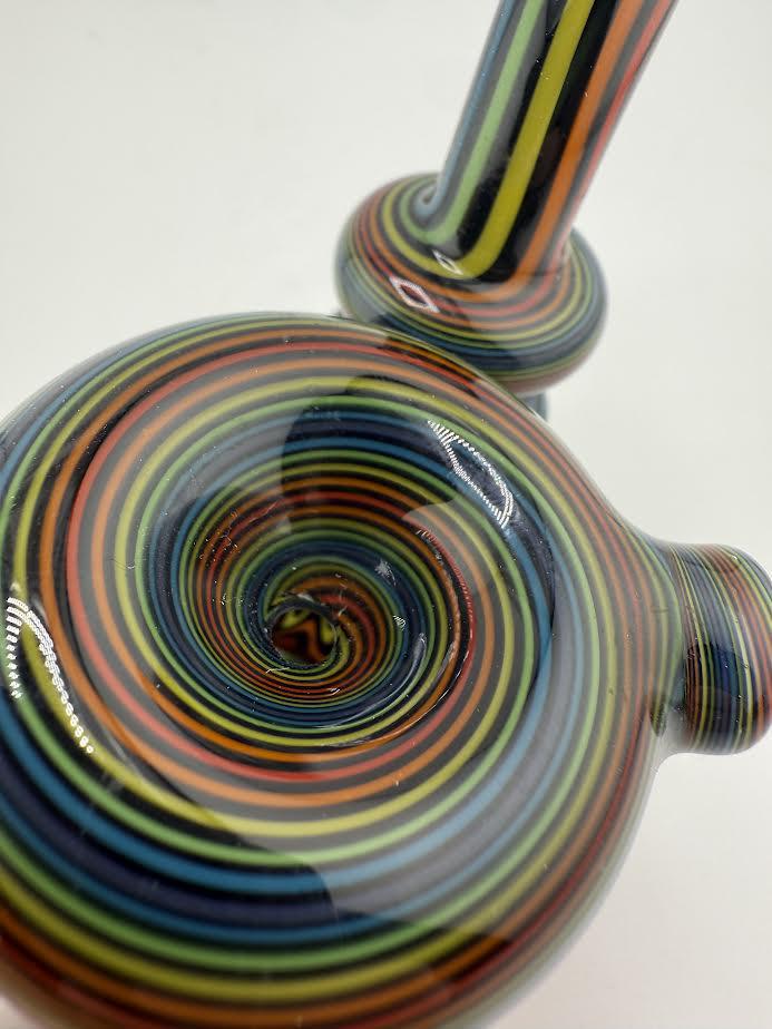 Close-up of Mcdoogle Sherlock line work pipe featuring vibrant, swirling colors and intricate design.