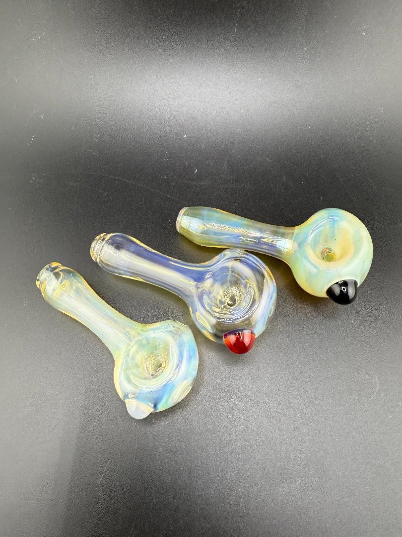 Highgrade Glass Simple Fumed Hand Pipes in various colors, showcasing hand-blown craftsmanship and a unique fumed finish.