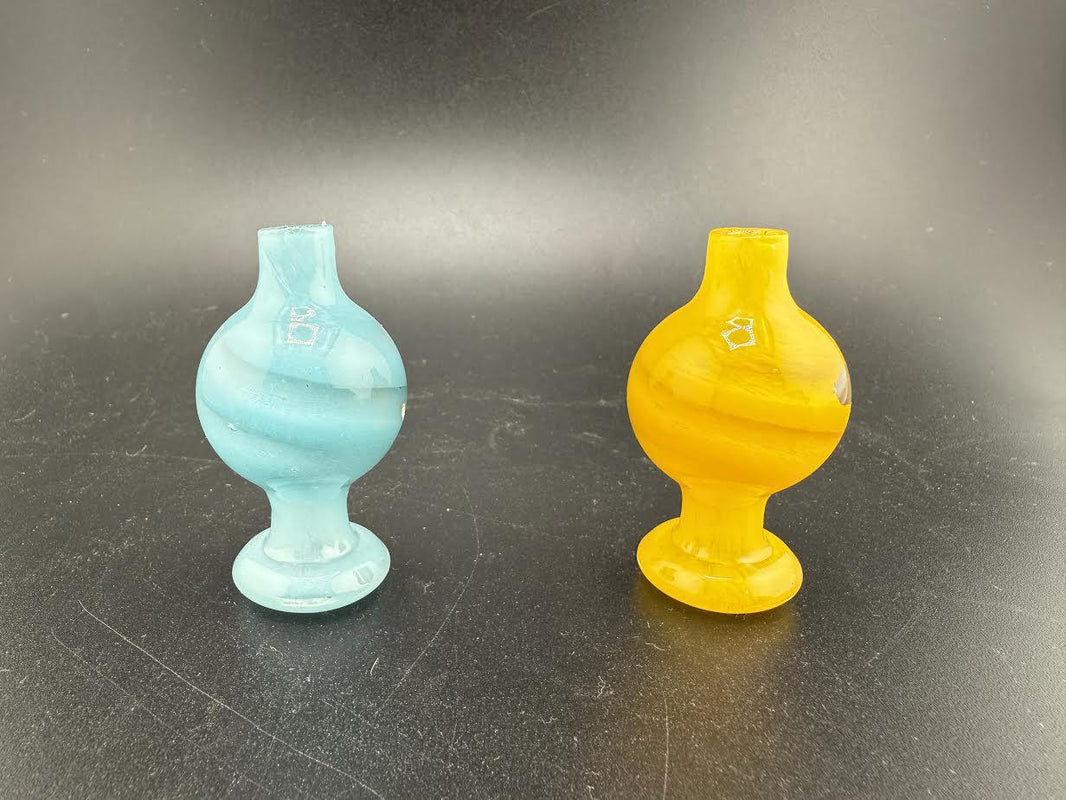 Two colorful Bolt Up Bubble Caps in blue and yellow, designed for enhancing smoking experiences.