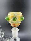 Close-up of a Crondo Glass fumed 14mm bowl piece with green accents and colorful patterns, showcasing intricate craftsmanship.