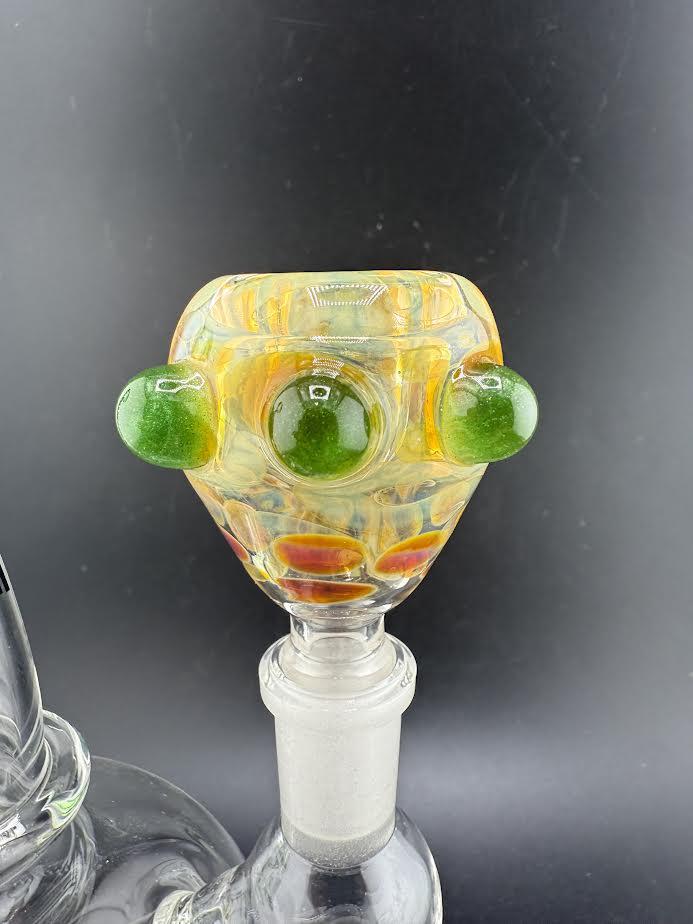 Close-up of a Crondo Glass fumed 14mm bowl piece with green accents and colorful patterns, showcasing intricate craftsmanship.
