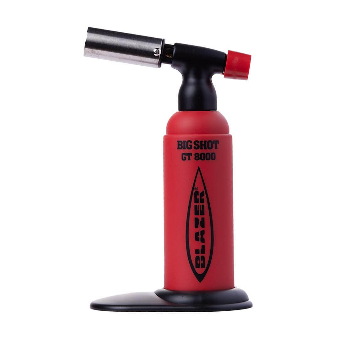 Blazer Big Shot GT8000 Butane Torch on a stand, showcasing precision engineering and portability.