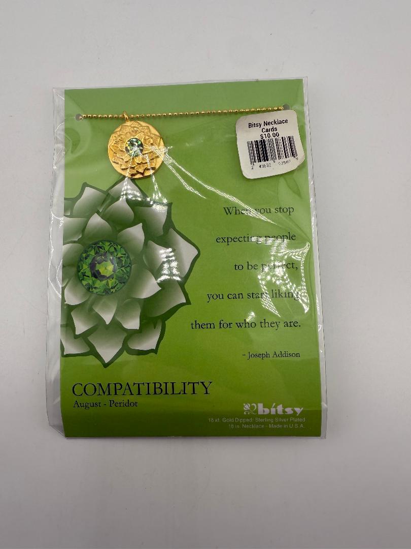 Bitsy Gemstone Birth Month Necklace displayed in packaging with green floral background and genuine gemstones.