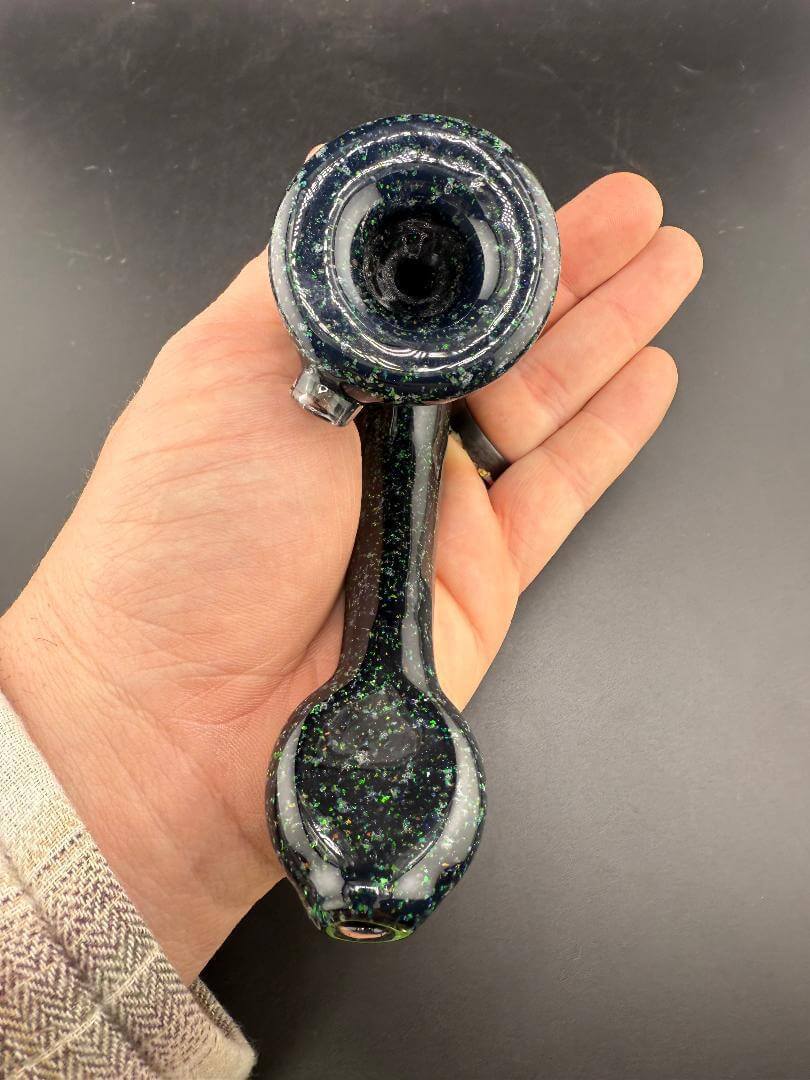 Filla John Glass Sherlock Pipe - Black Crushed Opal w/ Encased Opal Attachment in hand, showcasing intricate craftsmanship.