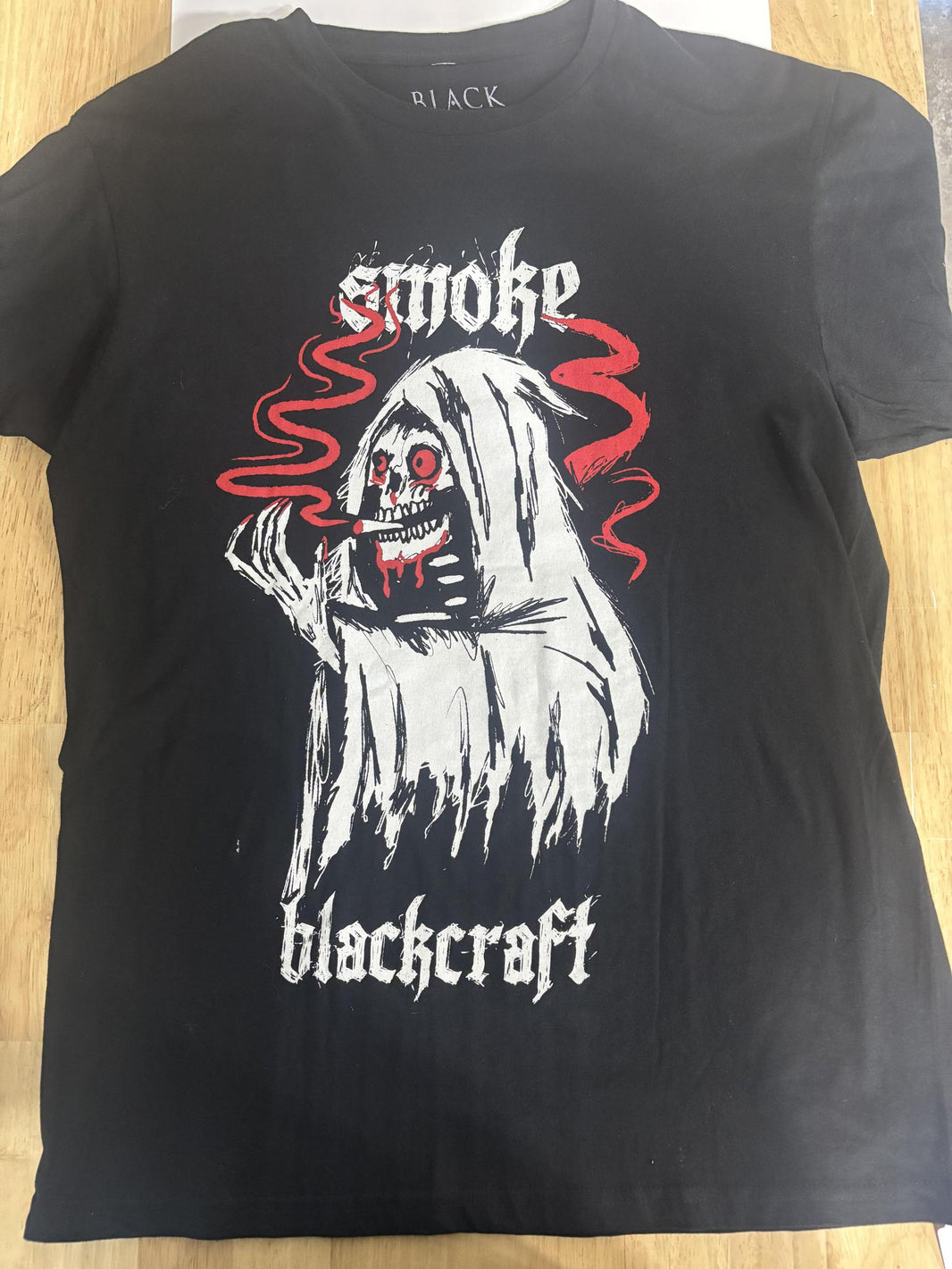 BlackCraft Cult T-shirt featuring a haunting graphic of a grim reaper with smoke and bold lettering.