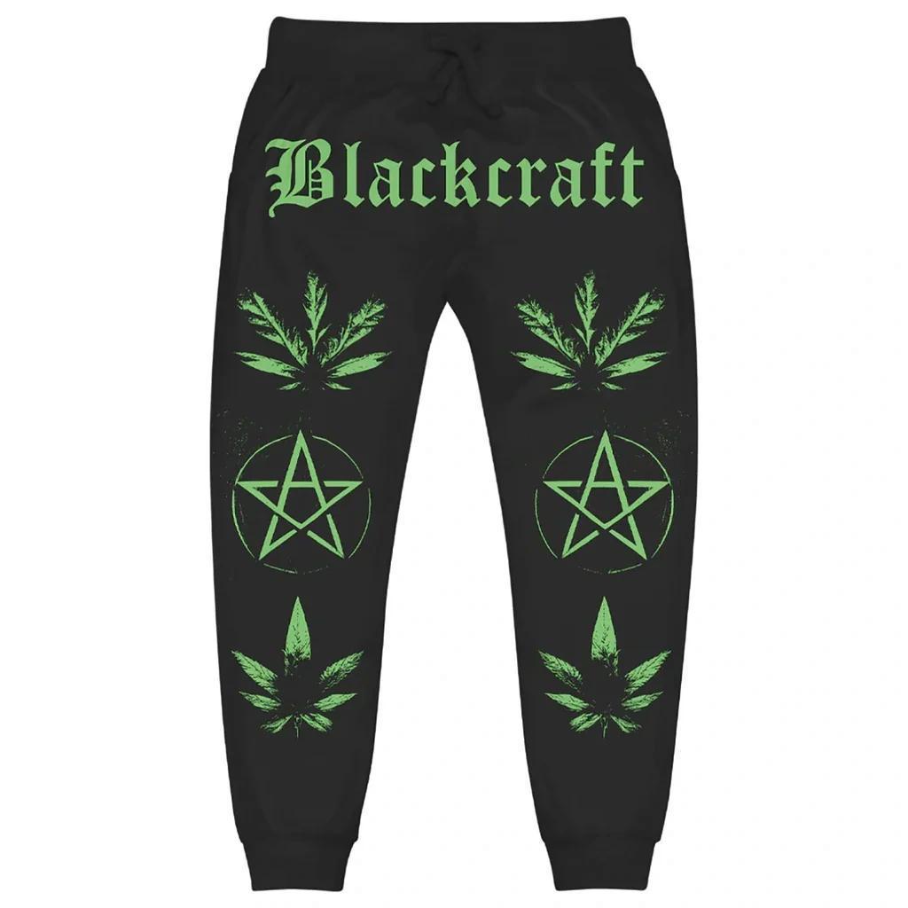 BlackCraft Cult Joggers featuring bold green graphics and occult iconography on a black background.