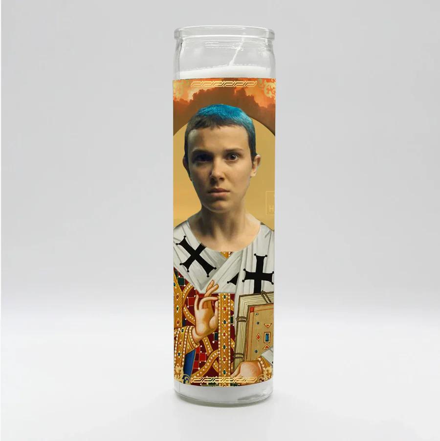 Bobbyk Saint Candles featuring an artistic candle with a blue-haired figure and intricate designs.