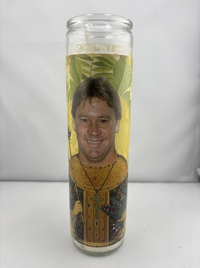 Bobbyk Saint Candles featuring parody design of a beloved figure on a tall, white prayer candle.