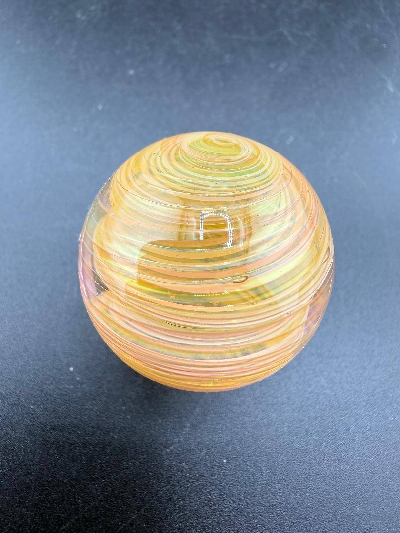 Brando Glass Gold Fumed Marble 1.3" showcasing vibrant colors and swirls under glossy surface.