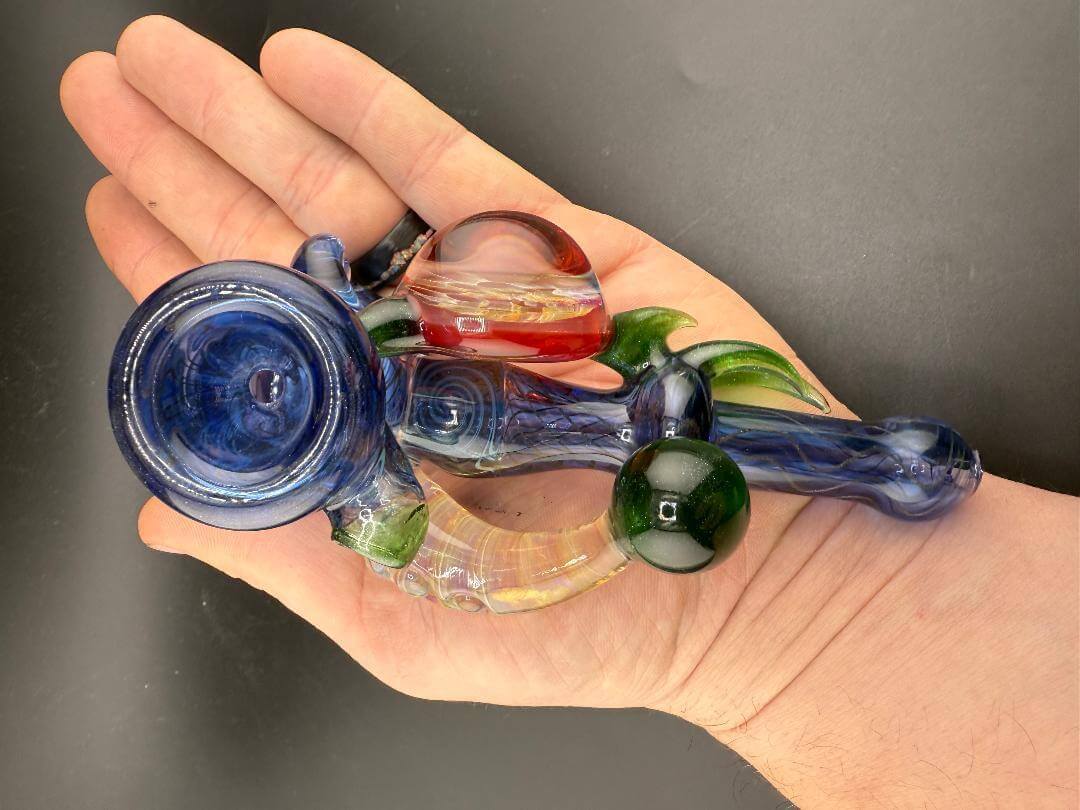 Brando Glass Hammer Pipe - Blue Space Tech w/ Honeycomb Pendant & Horn Attachment in hand showcasing intricate design.