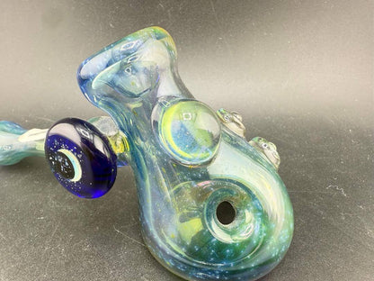 Brando Glass Hammer Pipe - Space Fume Tech w/ Cobalt Moon Pendant Attachment on a grey background.