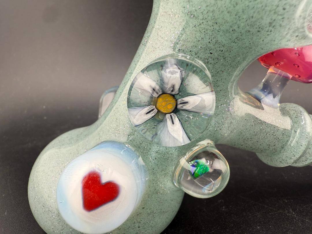 Brando Glass Hammer Pipe - Teal Sparkle UV Glow w/ Pink Mushroom & Rainbow Bright Millies features detailed glass artwork.