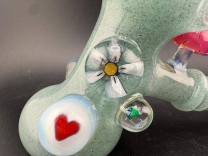 Brando Glass Hammer Pipe - Teal Sparkle UV Glow w/ Pink Mushroom & Rainbow Bright Millies features detailed glass artwork.