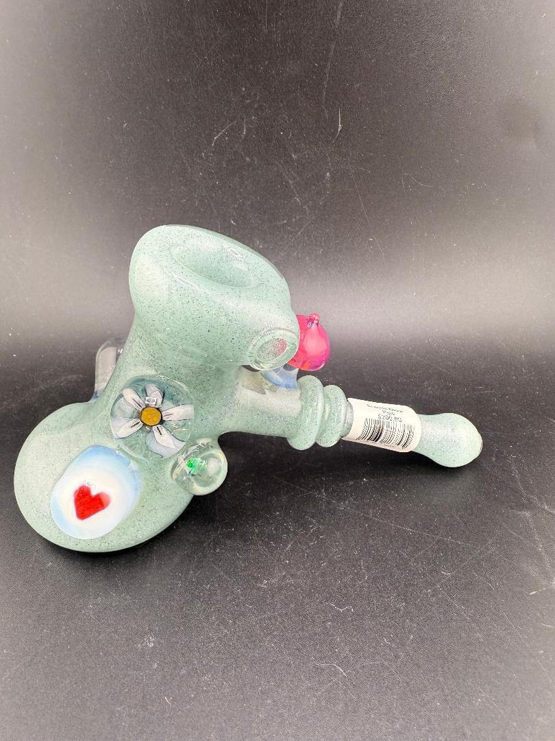 Brando Glass Hammer Pipe - Teal Sparkle UV Glow w/ Pink Mushroom & Rainbow Bright Millies on display.