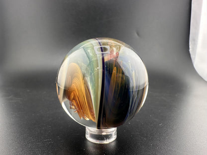 Brando Glass Large Marble - Swirled Backed Implosion showcasing vibrant colors and intricate design on a black background.