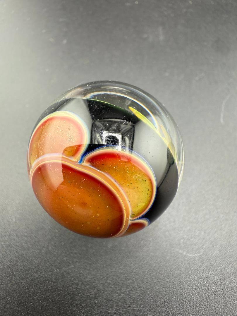 Brando Glass Marble - 30mm Fumed Implosion showcasing vibrant colors and dynamic implosion design.