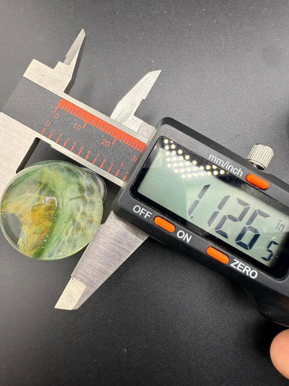 Brando Glass Marble - Double Vortex Approx. 1.15" being measured with caliper to show precise dimensions.
