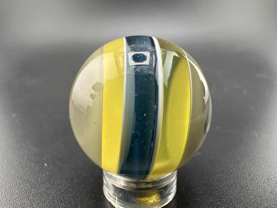 Brando Glass Marble - Enclamo showcasing vibrant layered colors and intricate detail in borosilicate glass.