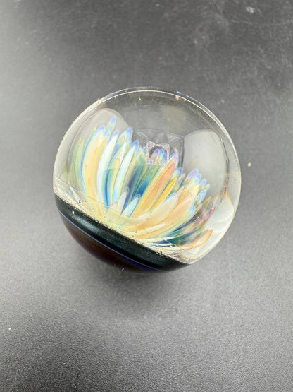 Brando Glass Marble - Frit Implosion Flower w/ Dichro Backer showcasing vibrant floral design and shimmering colors.