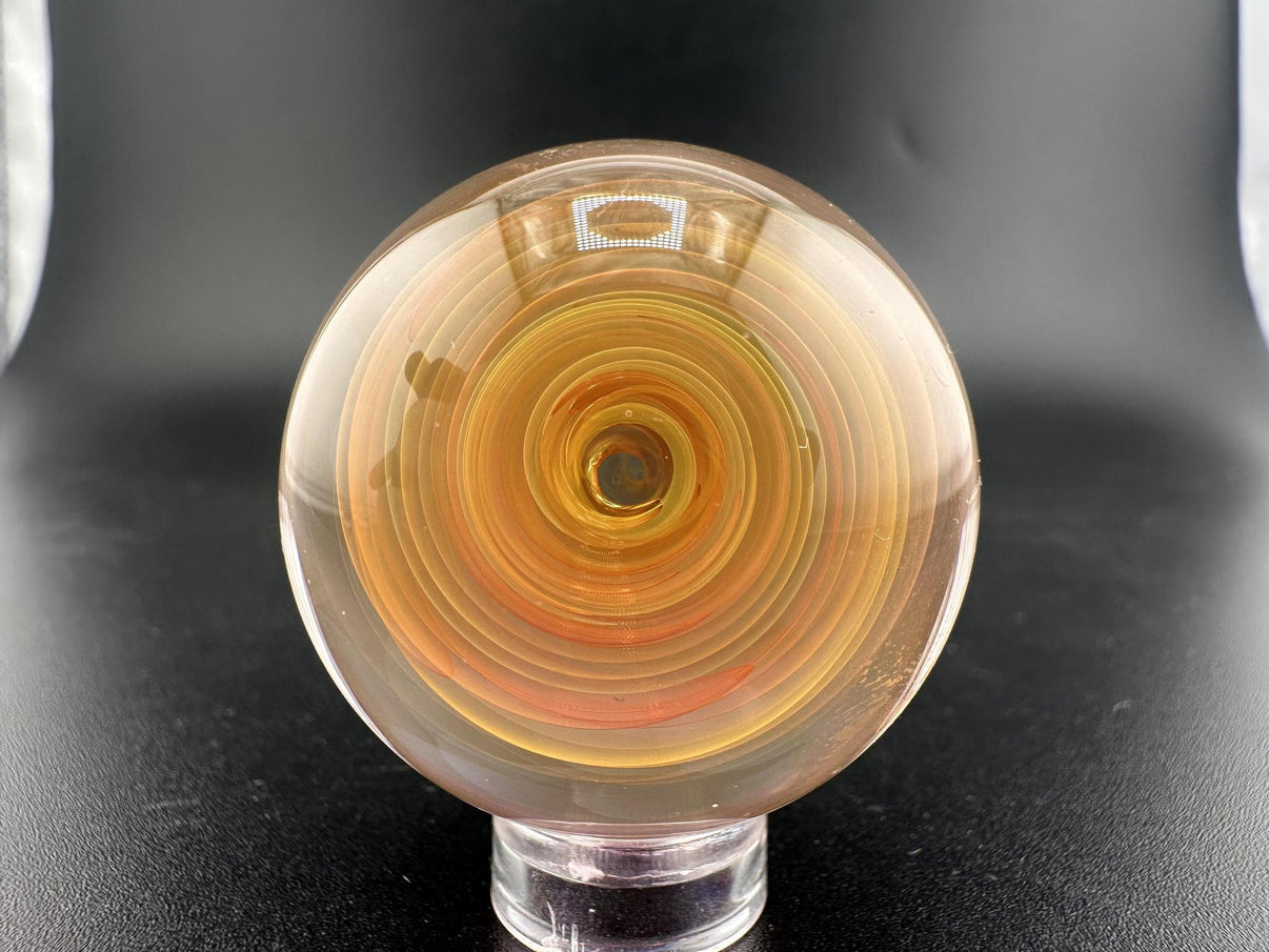 Brando Glass Marble - Fumed Swirl showcasing swirling gold and silver hues in handcrafted borosilicate glass.