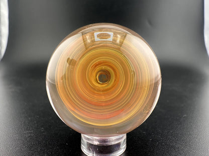 Brando Glass Marble - Fumed Swirl showcasing swirling gold and silver hues in handcrafted borosilicate glass.