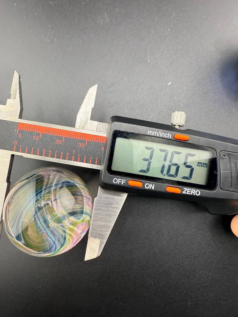 Brando Glass Marble -Large 37mm Clear Center Line Worked Outer being measured with calipers at 31.65mm.