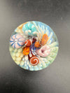 Brando Glass Marble - Sea Life Implosion 1.5" showcasing colorful sea anemones and urchins in clear glass.