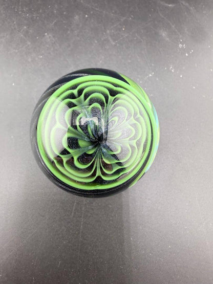 Brando Glass Marble - UV Green Fully Line Worked Twist 1.8" showcasing intricate spiral design under UV light.