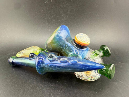 Brando Glass X Micahmazing Sidecar Pipe -Space Fume Tech & Liquid Filled placed artistically on a black background.