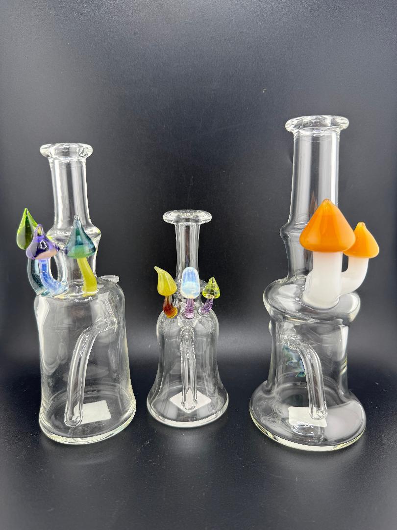 Brando Glass Mushroom Growth Banger Hanger Rig 10mm 90° – Trio of colorful hand-blown glass banger hangers with mushroom accents.