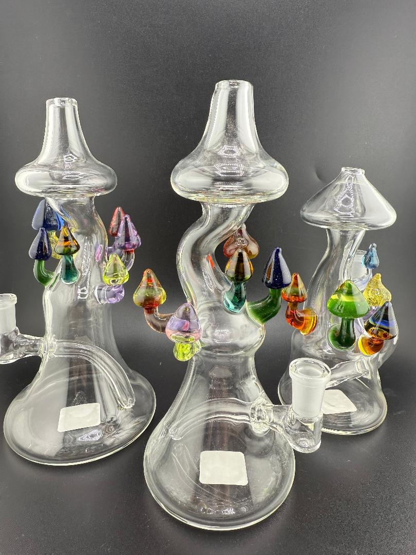 Brando Glass Mushroom Growth on Mushroom Rig 10mm 90° showcasing three unique hand-blown glass pieces with vibrant mushrooms.
