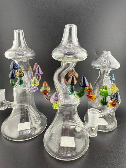 Brando Glass Mushroom Growth on Mushroom Rig 10mm 90° showcasing three unique hand-blown glass pieces with vibrant mushrooms.