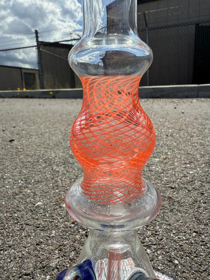 Brando Glass Orange Reticello tube with vibrant orange pattern, handcrafted in Spokane, WA, showcasing unique design.