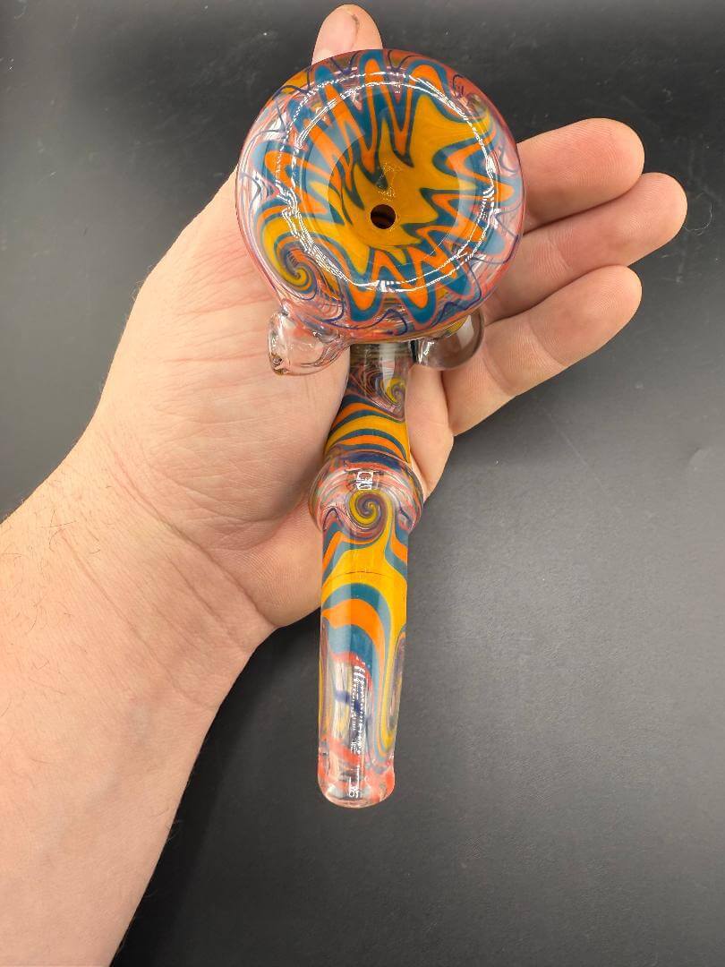Brando Glass Sherlock Pipe - Orange Yellow & Teal Wig Wag w/ Grateful Dead Millie Attachments held in hand.
