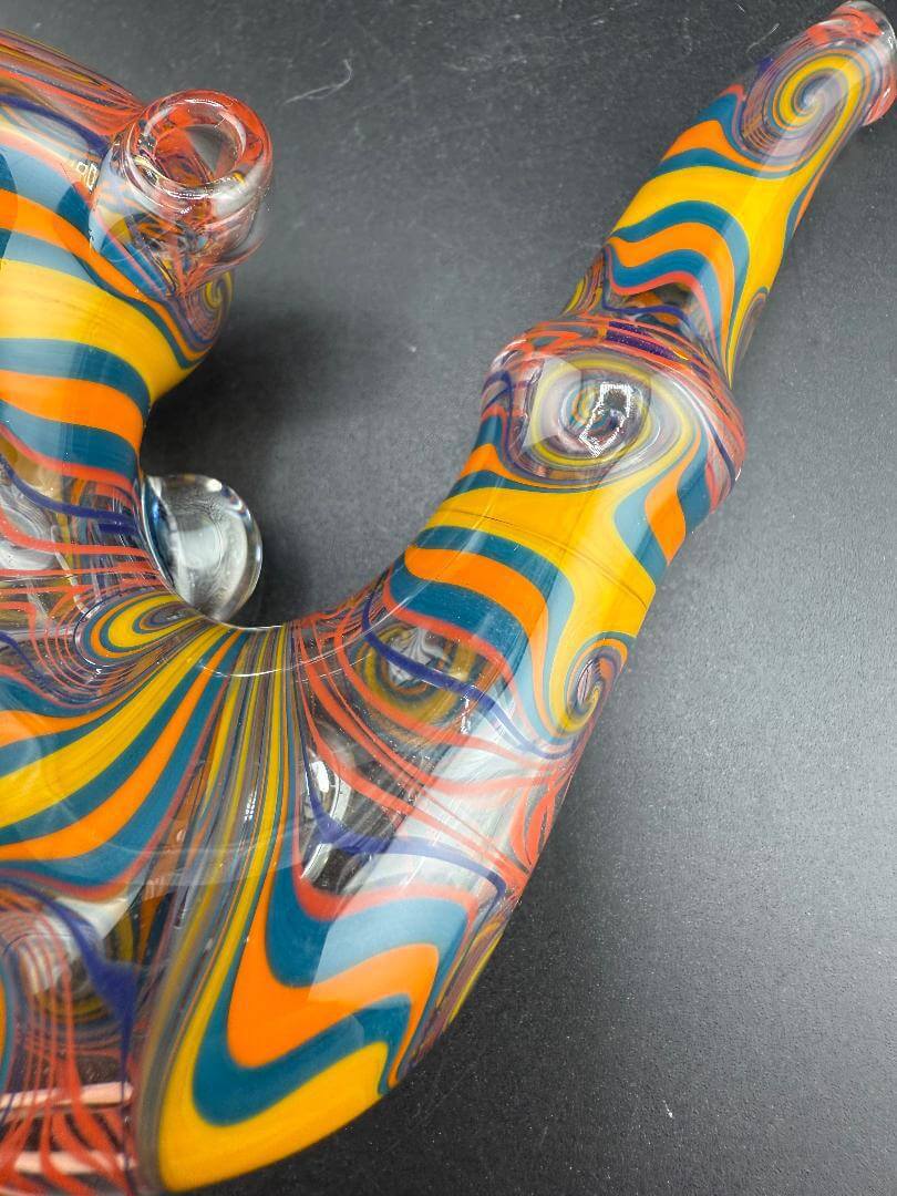Brando Glass Sherlock Pipe - Orange Yellow & Teal Wig Wag w/ Grateful Dead Millie Attachments close-up view.