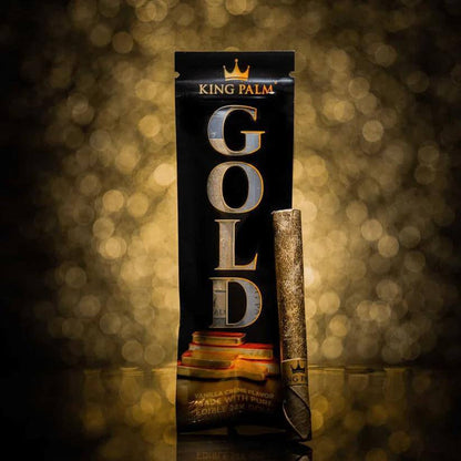 King Palm Vanilla Creme Flavor wrap with 24K edible gold, set against a golden bokeh background.