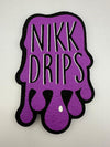 Nikk Drips logo in purple with a dripping design, representing a collaboration with MoodMats.