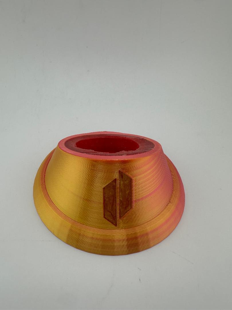Puffco Peak Pro glass stand in orange and red color for stylish display and protection of glass attachments.