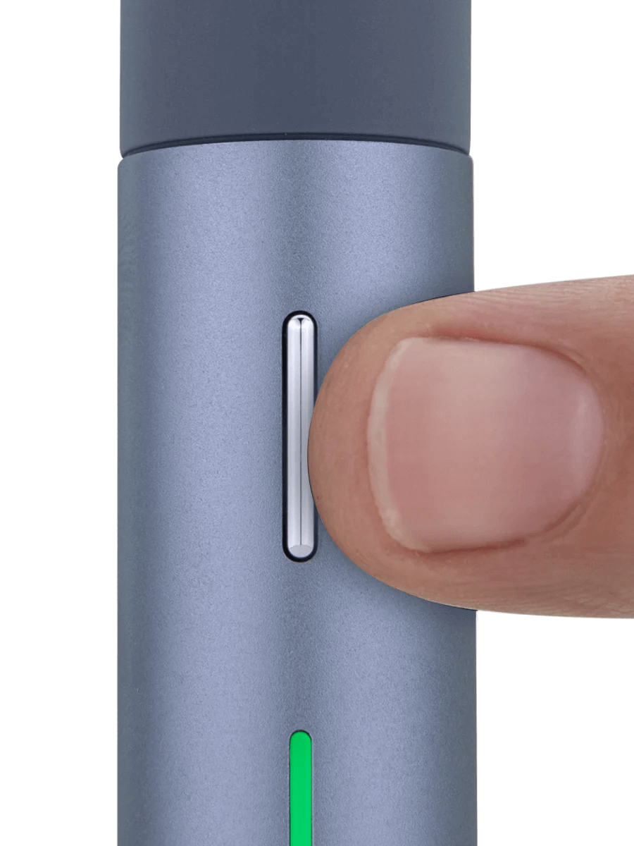 Close-up of the Puffco Pivot Mobile Vaporizer being activated with a finger on the button.