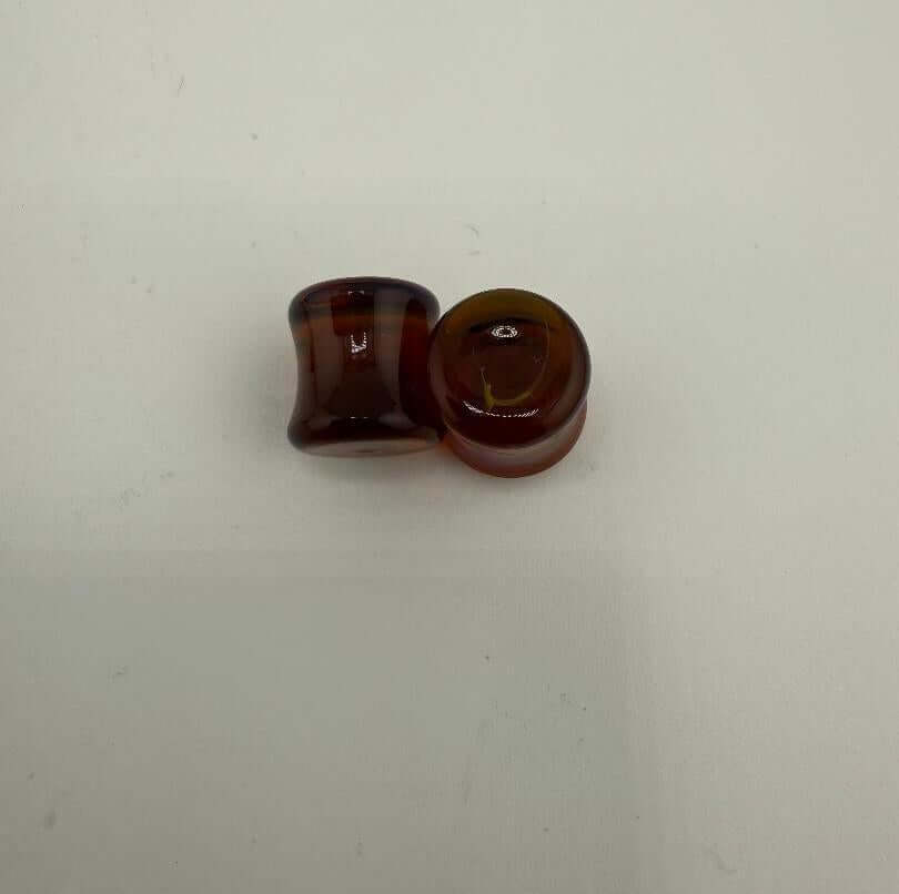 Paulson Pieces 9mm ear plugs made from handcrafted borosilicate glass in a rich amber color.