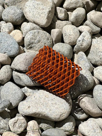 Heat Cage Sesh Essentials displayed on rocks, showcasing torch guard for Blazer Big Shot GT8000 and Big Buddy.
