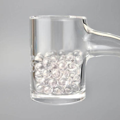 Ruby Pearl Co Clear Sapphire Terp Pearls in a glass banger for enhanced dabbing flavor and heat retention.