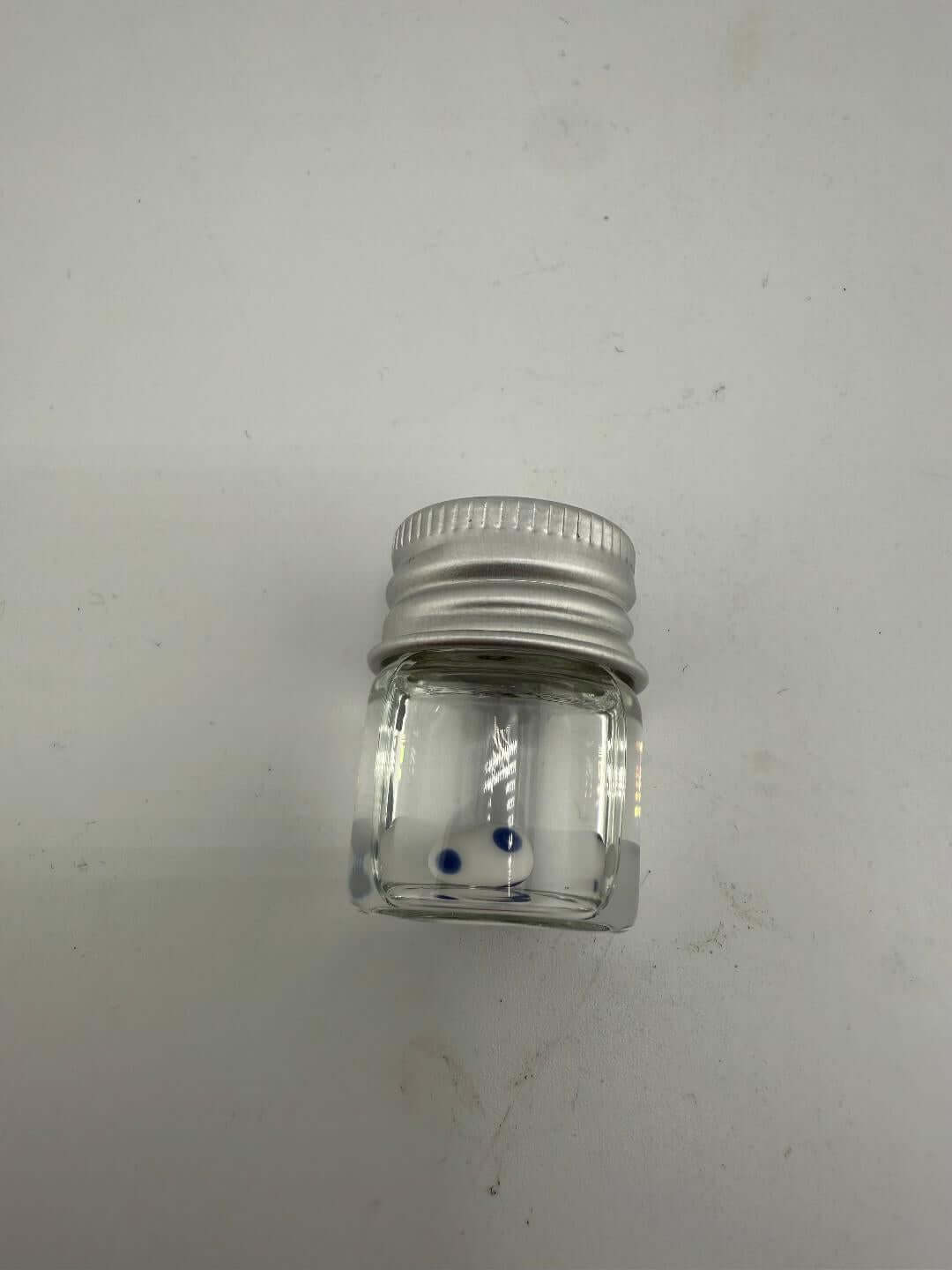 Lucky Gnome Glass Terp Pearl in clear jar with metal lid, featuring blue accents for enhanced dab sessions.