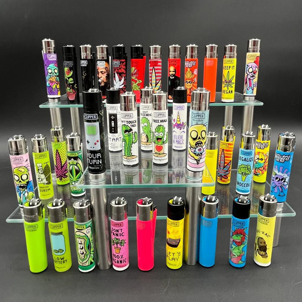Display of various Clipper Lighter - Random designs on a glass shelf