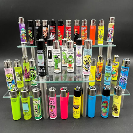 Display of various Clipper Lighter - Random designs on a glass shelf