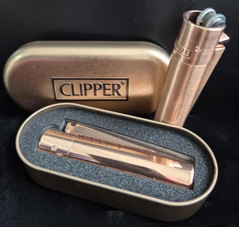 Clipper Metal Lighter Rose Gold in case, showcasing sleek rose gold design and refillable features.