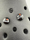 Close-up of two black glass buttons reading 'Cool' and 'Boo', set against a textured surface.