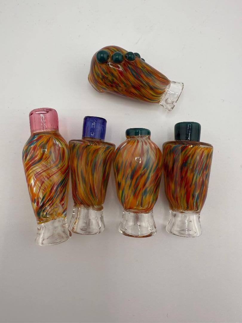 Colorful handcrafted glass replacement tops for Puffco devices featuring swirled designs.