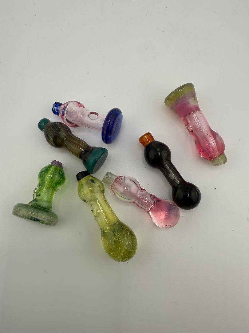 Colorful assortment of handcrafted glass ball caps for dabbing, showcasing various shapes and sizes.